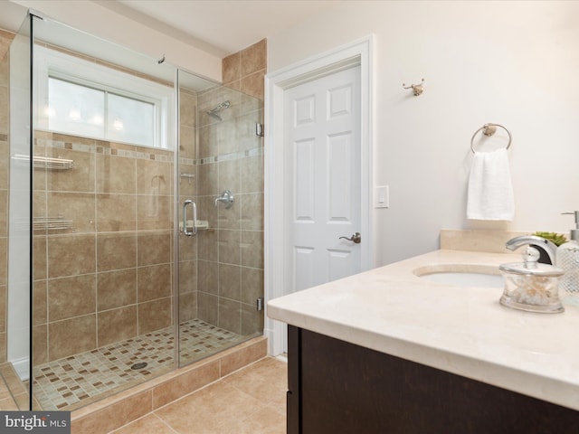 bathroom featuring vanity, tile patterned floors, and a stall shower