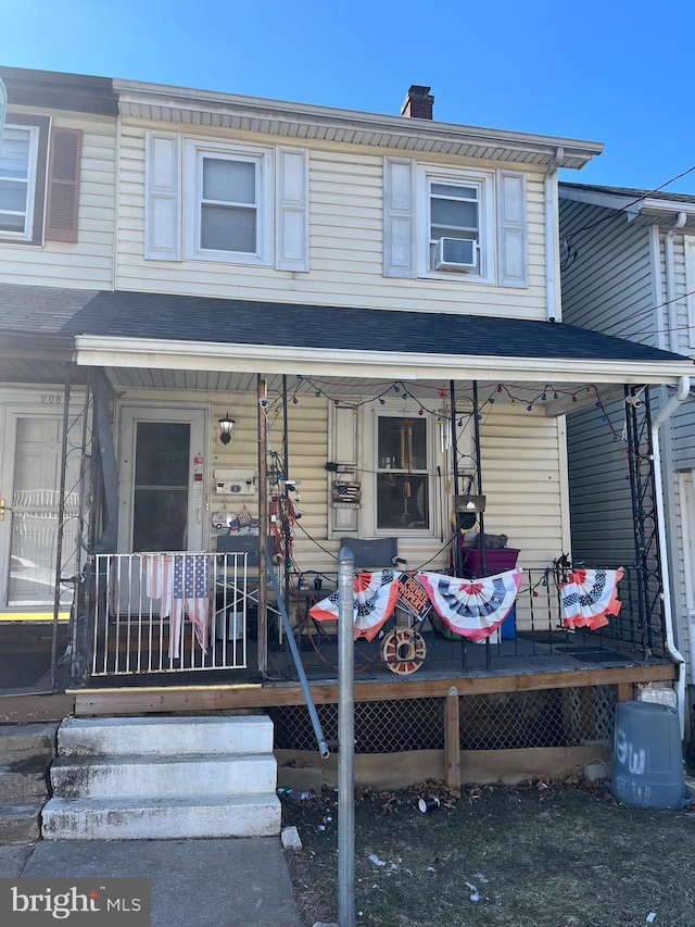 view of front of home with a porch and a chimney