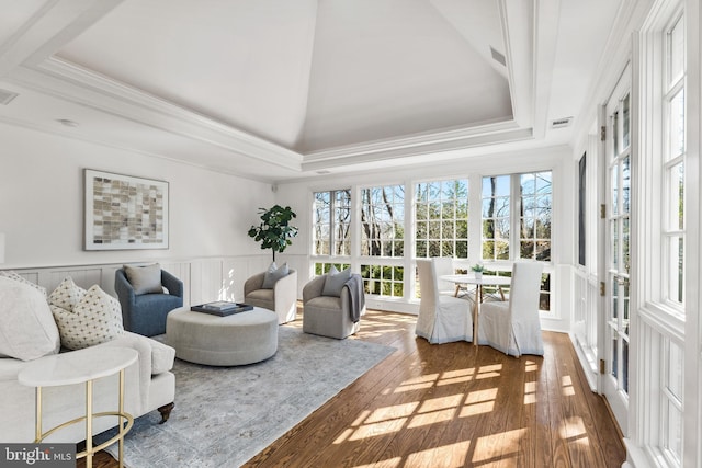 sunroom / solarium featuring visible vents and a raised ceiling