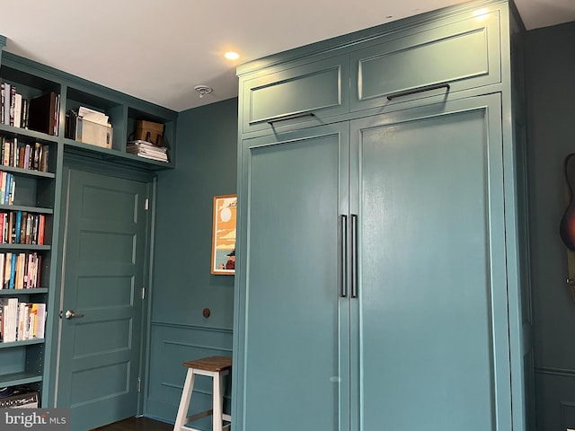 interior space with open shelves and paneled refrigerator