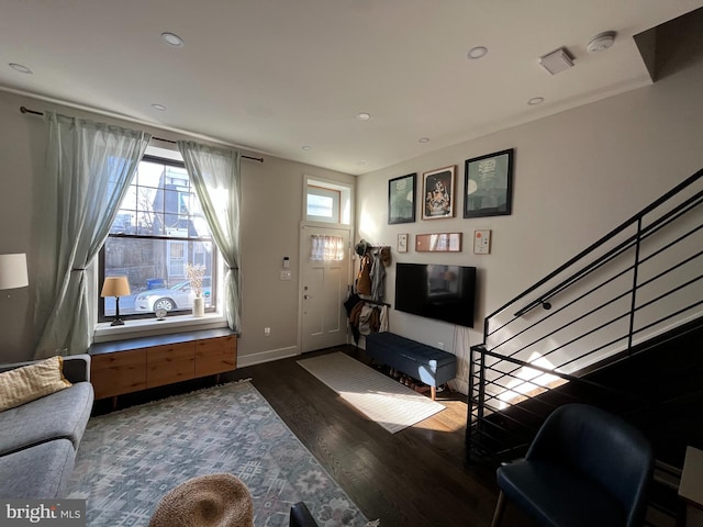 entrance foyer featuring baseboards, stairway, wood finished floors, and recessed lighting