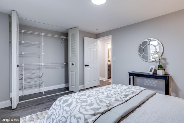 bedroom featuring a closet, baseboards, and wood finished floors