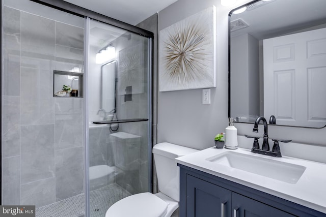 bathroom with toilet, a stall shower, vanity, and visible vents