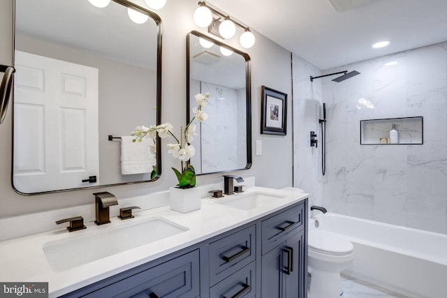 bathroom featuring marble finish floor, a sink, toilet, and double vanity