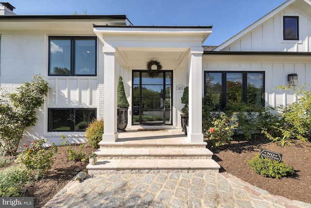 entrance to property featuring brick siding and board and batten siding