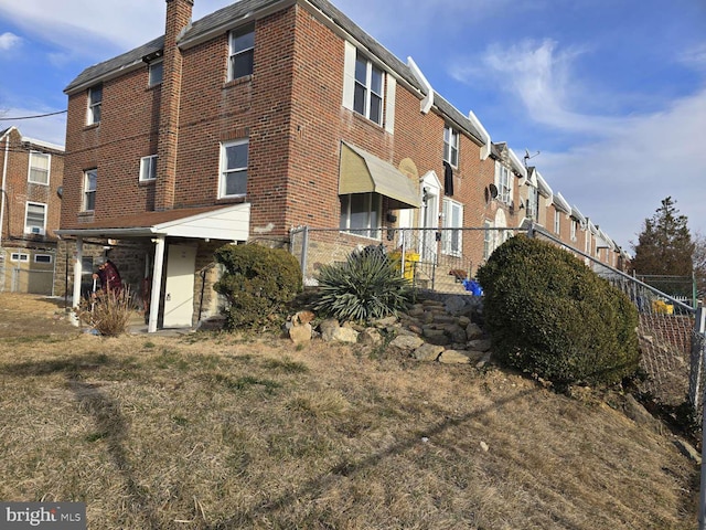 view of property featuring fence and a residential view