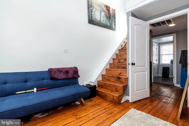 interior space featuring stairway, wood finished floors, visible vents, and baseboards