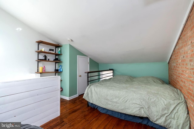 bedroom featuring lofted ceiling, dark wood-style floors, and baseboards