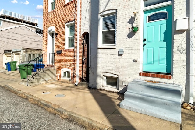 property entrance with brick siding