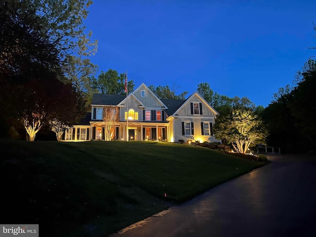 view of front of property with driveway, a front lawn, and board and batten siding