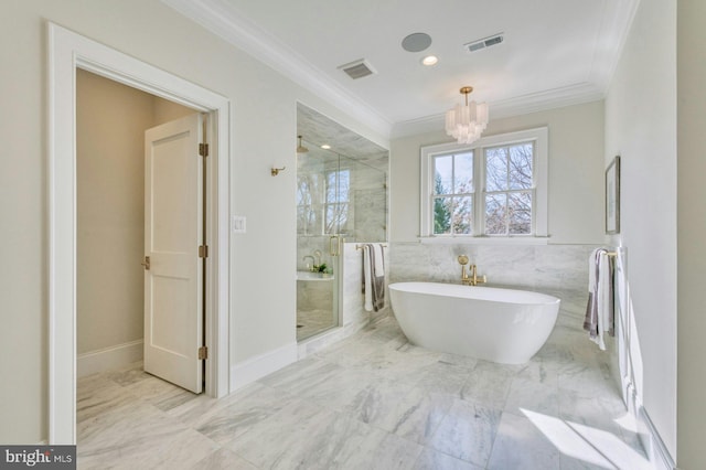 bathroom featuring crown molding, visible vents, and a freestanding bath