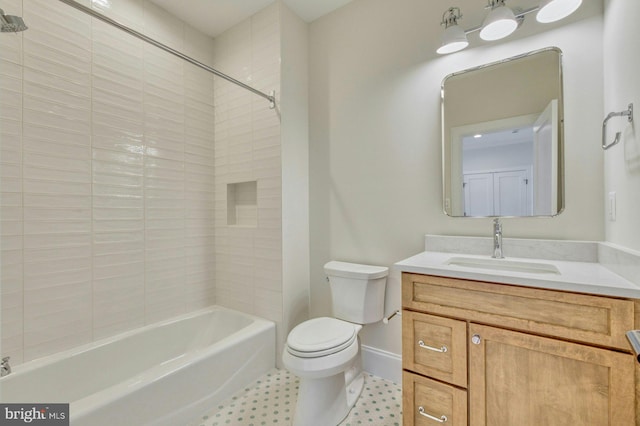 bathroom featuring toilet, bathtub / shower combination, vanity, and baseboards