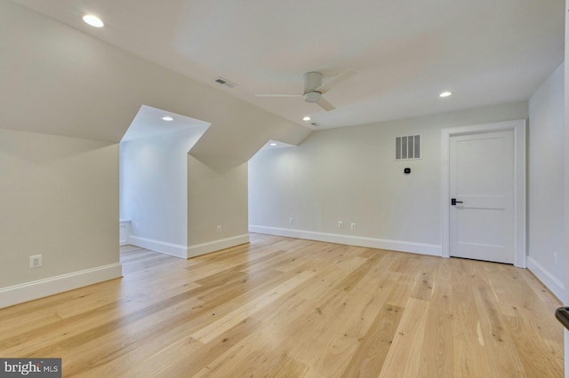 additional living space featuring ceiling fan, light wood-type flooring, visible vents, and baseboards