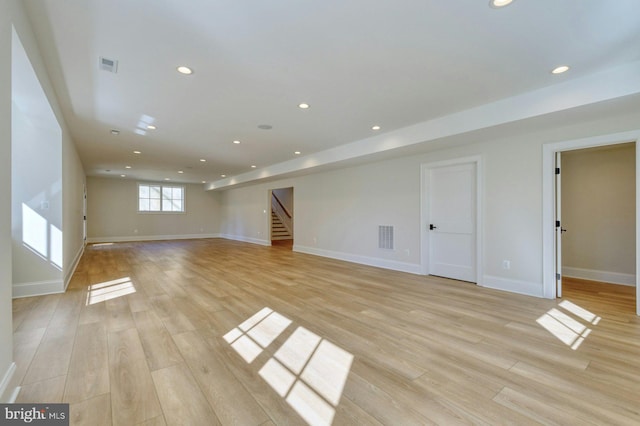 interior space with light wood-type flooring, stairway, visible vents, and recessed lighting