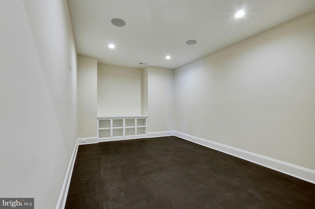 unfurnished room featuring recessed lighting and baseboards