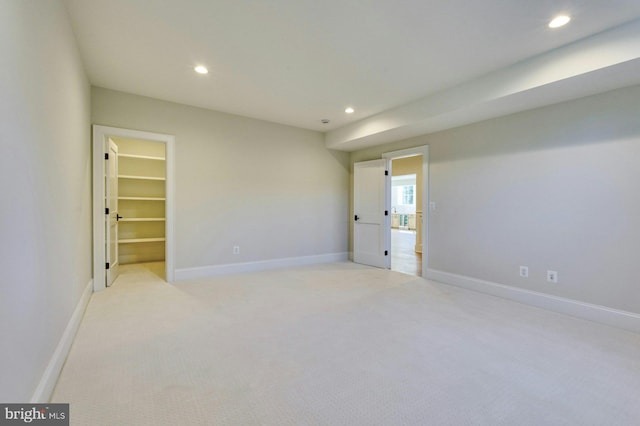 unfurnished room featuring baseboards, light colored carpet, and recessed lighting