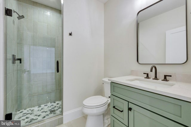 full bath featuring baseboards, toilet, tile patterned floors, vanity, and a shower stall