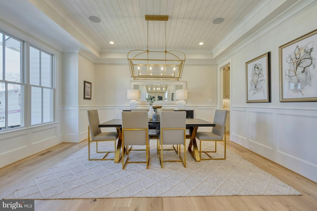 dining area with plenty of natural light, wood ceiling, and a decorative wall