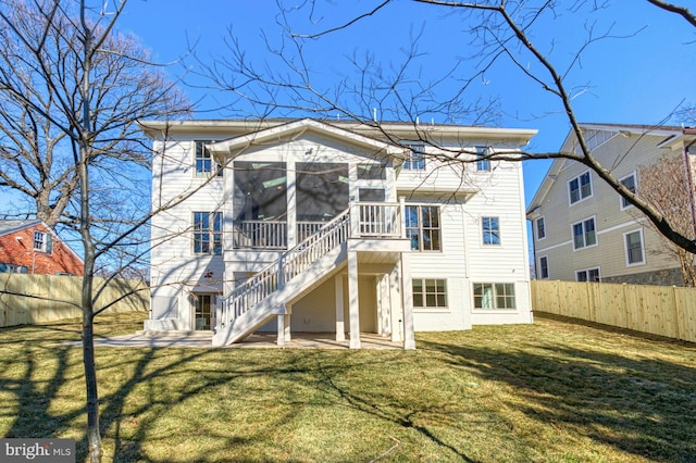 back of house with a sunroom, a fenced backyard, stairs, and a patio