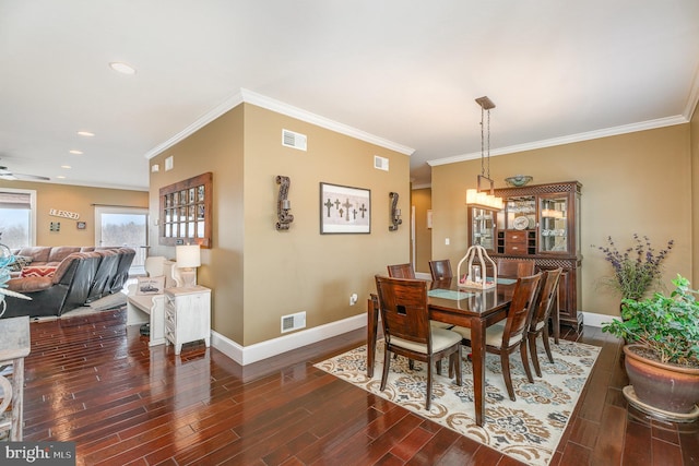 dining area with dark wood-style floors, visible vents, and baseboards