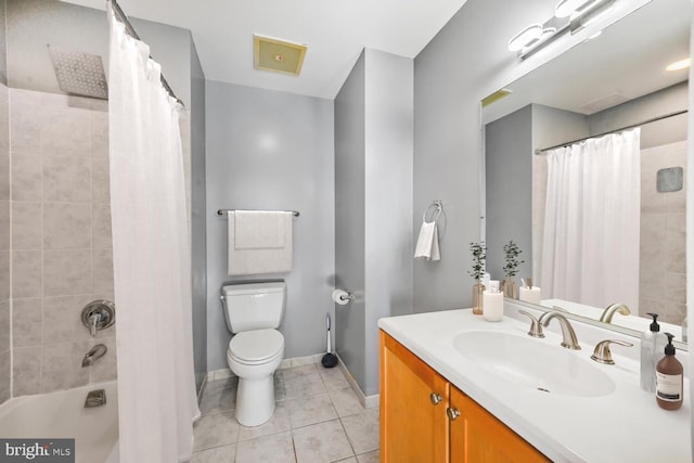 bathroom featuring visible vents, toilet, vanity, baseboards, and tile patterned floors