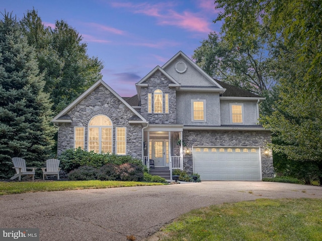 traditional-style home featuring an attached garage and concrete driveway