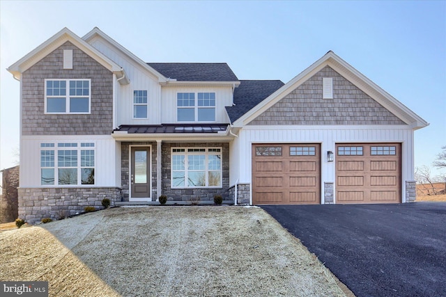 view of front of home featuring driveway, metal roof, an attached garage, a standing seam roof, and board and batten siding