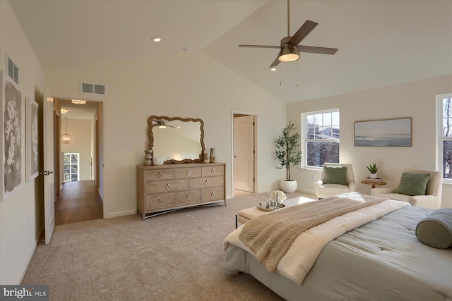 bedroom with high vaulted ceiling, visible vents, light carpet, and a ceiling fan