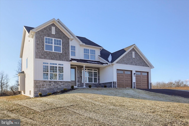 craftsman house with metal roof, aphalt driveway, an attached garage, a standing seam roof, and a front yard