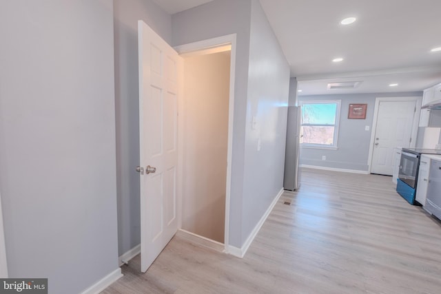 corridor featuring recessed lighting, light wood-style flooring, and baseboards