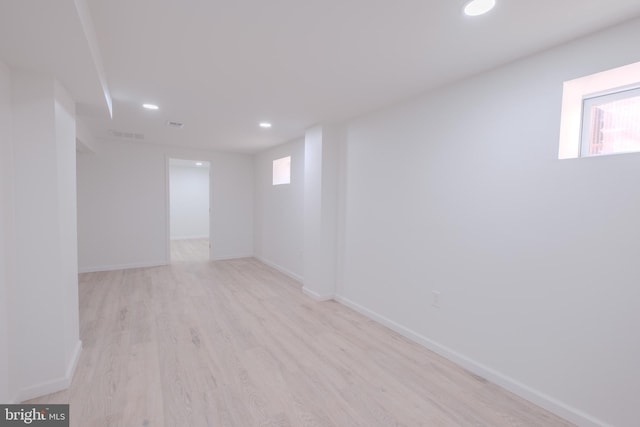 empty room with a healthy amount of sunlight, light wood-style flooring, and recessed lighting