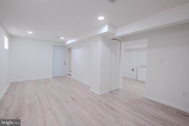 below grade area featuring light wood-style floors, baseboards, and recessed lighting