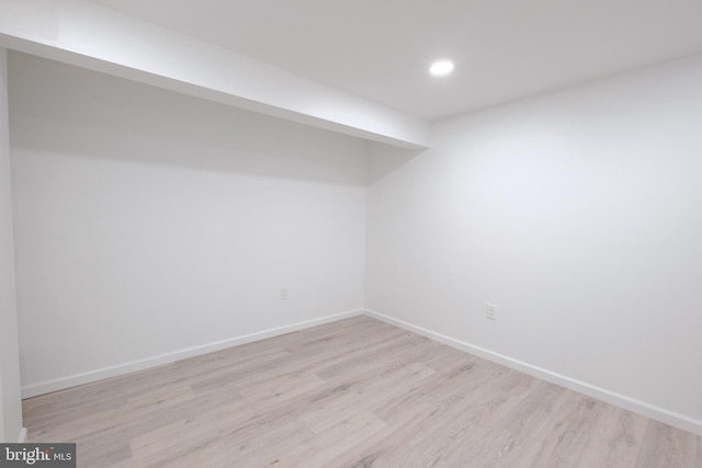 empty room with recessed lighting, light wood-style flooring, and baseboards