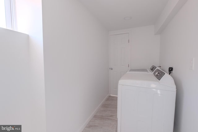 laundry area with laundry area, baseboards, and independent washer and dryer