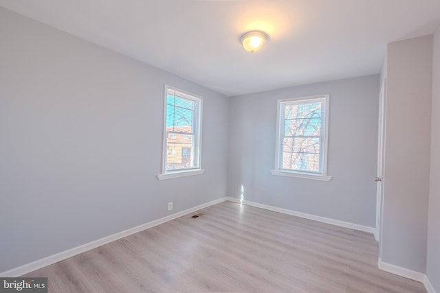 unfurnished room featuring light wood-style floors and baseboards