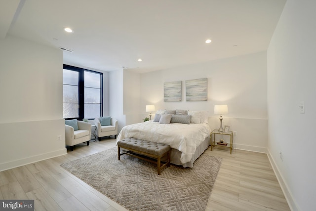 bedroom with recessed lighting, light wood-type flooring, and baseboards