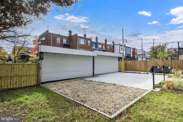 rear view of house with a residential view, fence, a patio, and central air condition unit