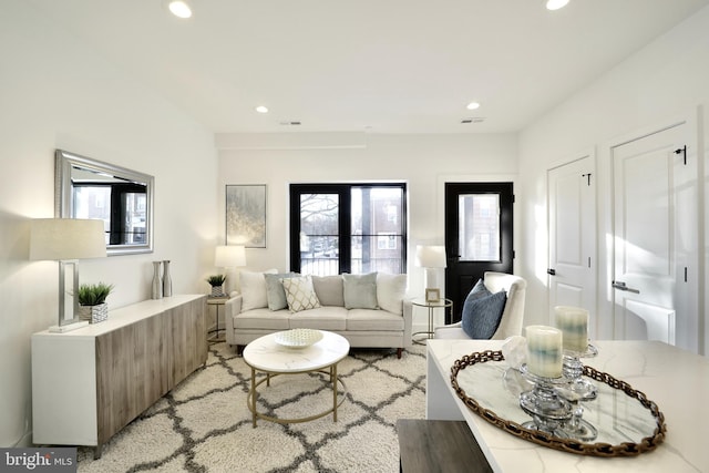 living area with recessed lighting, visible vents, and plenty of natural light