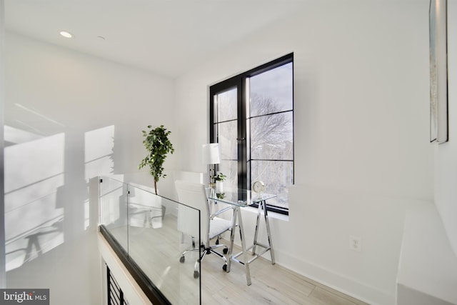 home office with light wood finished floors and baseboards