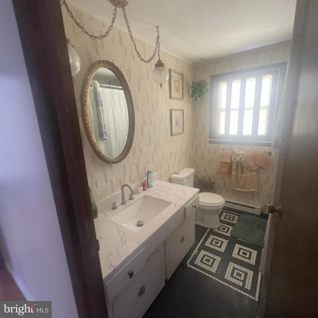 full bathroom featuring wallpapered walls, toilet, vanity, and a baseboard heating unit