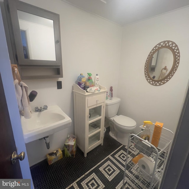 half bathroom with tile patterned flooring and toilet