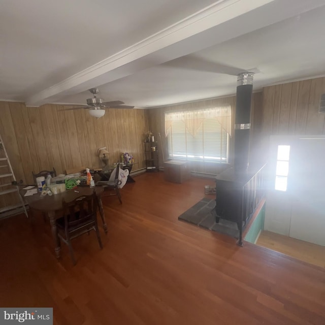 dining area featuring beam ceiling, a healthy amount of sunlight, ceiling fan, and wood finished floors