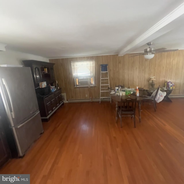 unfurnished dining area featuring ceiling fan, cooling unit, wood finished floors, and a baseboard radiator