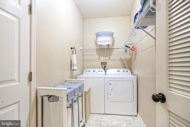 washroom featuring laundry area, independent washer and dryer, and baseboards