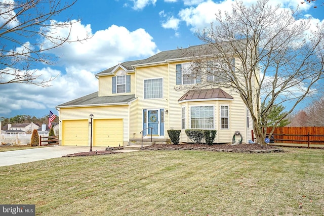 traditional home featuring a front yard, fence, driveway, and an attached garage