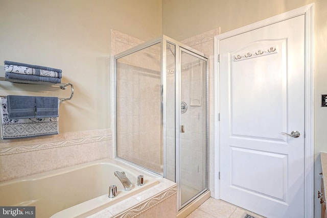 full bathroom featuring tile patterned flooring, a shower stall, and a bath