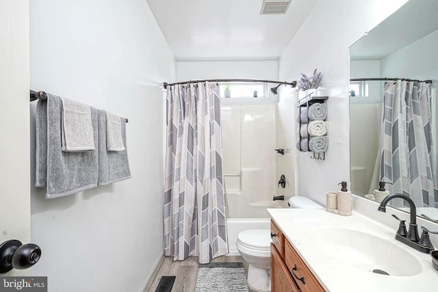 bathroom featuring visible vents, wood finished floors, vanity, and toilet