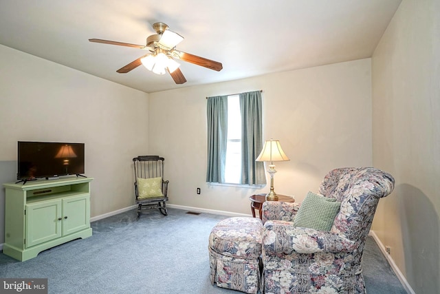 living area with ceiling fan, carpet floors, visible vents, and baseboards