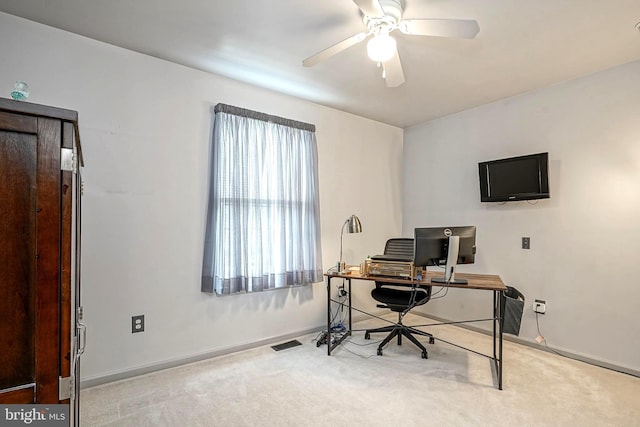 carpeted home office featuring ceiling fan, visible vents, and baseboards