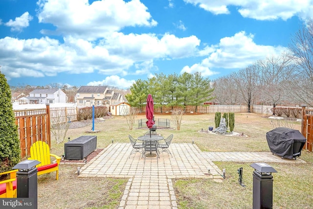 view of yard featuring a patio, a shed, an outdoor structure, and a fenced backyard